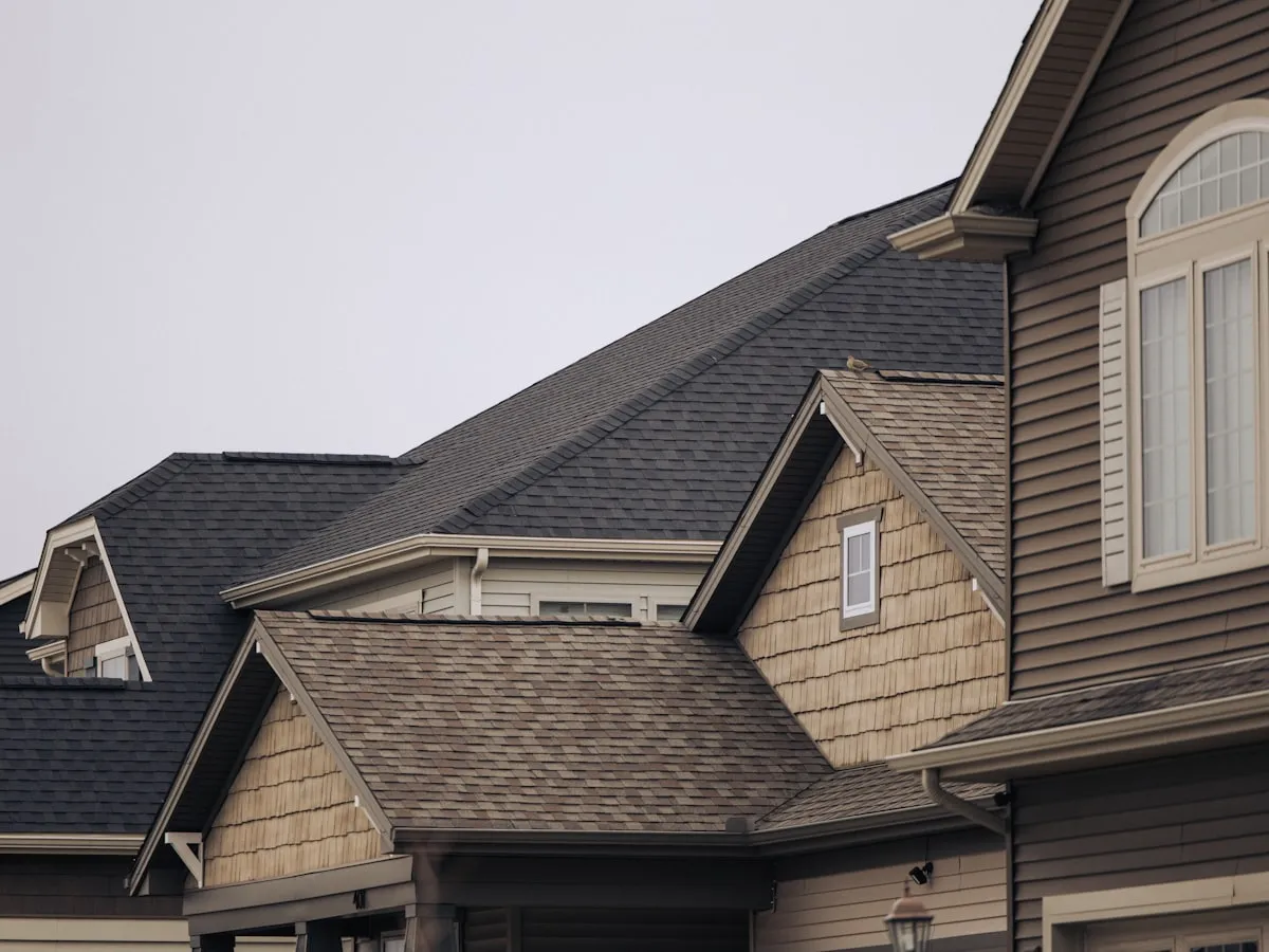 Suburban home with a new brown architectural shingle roof and dormers