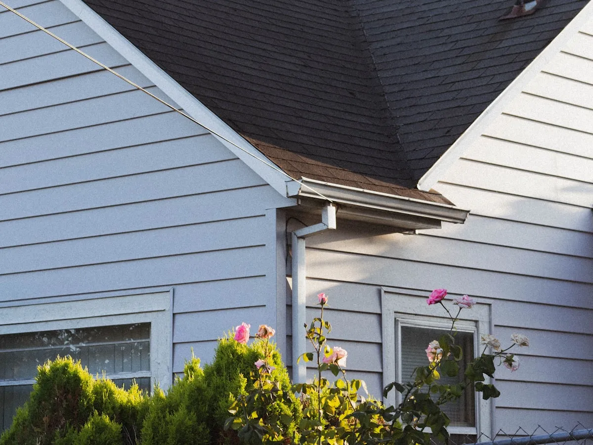 Restored white home with a crisp new gray shingle roof