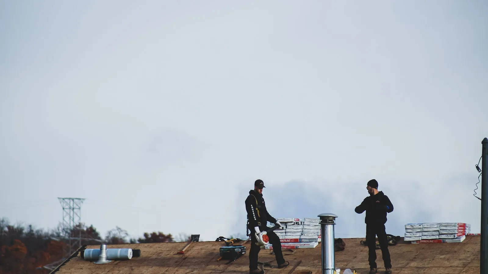 Two roofers working on a commercial flat roof