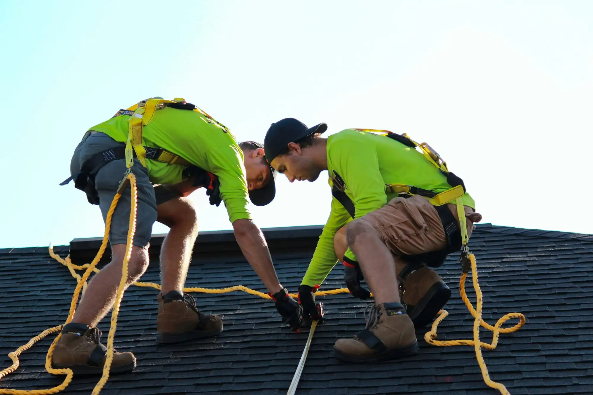 Ridgeline Roofing Co. crew installing architectural shingles on a residential roof